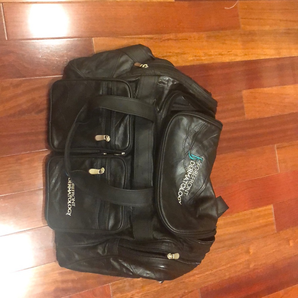 Black leather cargo bag by Forefront Dermatology